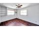 Clean bedroom with hardwood flooring, ceiling fan, and large windows offering ample natural light at 3119 Roberta St, Largo, FL 33771
