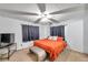 Cozy bedroom with a ceiling fan, large window, and a TV at 3119 Roberta St, Largo, FL 33771