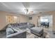 Inviting living room with grey sectional, ottoman, and view into the dining area at 3119 Roberta St, Largo, FL 33771