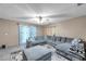 Comfortable living room with a large sectional sofa, patterned rug, and neutral wall color at 3119 Roberta St, Largo, FL 33771