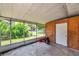 Screened porch featuring concrete flooring, backyard view, and a door for storage at 3119 Roberta St, Largo, FL 33771