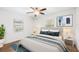 Bright bedroom with decorative lamps, ceiling fan, and an inviting bed at 3215 W Villa Rosa St, Tampa, FL 33611