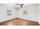 This bright bedroom has wood floors, a ceiling fan, and two windows that let in plenty of natural light at 3215 W Villa Rosa St, Tampa, FL 33611