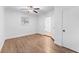 Bright bedroom with wood floors, ceiling fan, and natural light streaming in, leading to the en suite bathroom at 3215 W Villa Rosa St, Tampa, FL 33611