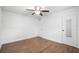 This bedroom features wood floors and a ceiling fan and a closet with a mirror door at 3215 W Villa Rosa St, Tampa, FL 33611