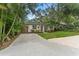 Charming single-story home with a well-manicured lawn and mature trees at 3215 W Villa Rosa St, Tampa, FL 33611