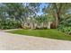 Charming single-story home with a well-manicured lawn and mature trees at 3215 W Villa Rosa St, Tampa, FL 33611