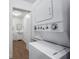 A utility room with a stacked washer and dryer and access to the bathroom at 3215 W Villa Rosa St, Tampa, FL 33611