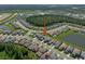 An aerial view of the home in a community near a beautiful wooded area and pond at 3326 Acacia Bay Ave, Wesley Chapel, FL 33543