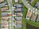 Aerial view of a home located on a quiet street with well-maintained lawns and mature trees at 3326 Acacia Bay Ave, Wesley Chapel, FL 33543