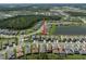 Community aerial view highlights proximity to green spaces and a pond at 3326 Acacia Bay Ave, Wesley Chapel, FL 33543