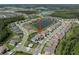 Community aerial view highlights proximity to green spaces and a lake at 3326 Acacia Bay Ave, Wesley Chapel, FL 33543