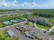 Aerial view showing community amenities including tennis courts, pool, clubhouse, and parking at 3326 Acacia Bay Ave, Wesley Chapel, FL 33543