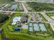 Community aerial view featuring a resort-style pool, tennis courts, and clubhouse at 3326 Acacia Bay Ave, Wesley Chapel, FL 33543