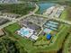 Overhead shot highlighting a community pool, tennis courts, and recreational amenities at 3326 Acacia Bay Ave, Wesley Chapel, FL 33543