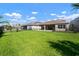 Expansive backyard featuring a well-maintained lawn and partial fencing at 3326 Acacia Bay Ave, Wesley Chapel, FL 33543