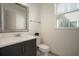 Modern half bath with stylish mirror, sink, cabinet and a bright window at 3326 Acacia Bay Ave, Wesley Chapel, FL 33543