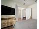 Elegant bedroom features a TV, white walls, and stylish furniture, offering a comfortable and relaxing environment at 3326 Acacia Bay Ave, Wesley Chapel, FL 33543