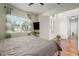 Inviting bedroom with natural light, ceiling fan, and view to the front yard from the beautiful windows at 3326 Acacia Bay Ave, Wesley Chapel, FL 33543