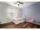 Well-lit bedroom with modern ceiling fan, wood floors, soft decor, and a cozy aesthetic, perfect for relaxation at 3326 Acacia Bay Ave, Wesley Chapel, FL 33543