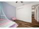 Bedroom offering modern style with wood floors, a soft canopy bed, and natural light from a large window at 3326 Acacia Bay Ave, Wesley Chapel, FL 33543