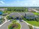 Aerial view featuring the clubhouse with roundabout and surrounding community amenities at 3326 Acacia Bay Ave, Wesley Chapel, FL 33543