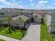 Stunning home features a three-car garage, lush landscaping, and a beautiful paver driveway at 3326 Acacia Bay Ave, Wesley Chapel, FL 33543