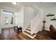 Light and bright foyer features wood flooring and a staircase at 3326 Acacia Bay Ave, Wesley Chapel, FL 33543