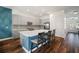 Bright kitchen featuring an island with seating, stainless appliances, and tile backsplash at 3326 Acacia Bay Ave, Wesley Chapel, FL 33543
