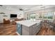 Open-concept kitchen with island seating, and easy access to a relaxing living space at 3326 Acacia Bay Ave, Wesley Chapel, FL 33543
