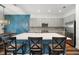 Modern kitchen featuring an island with seating, stylish lighting, and ample cabinet space at 3326 Acacia Bay Ave, Wesley Chapel, FL 33543
