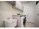 Functional laundry room with modern washer and dryer, ample storage, and a convenient sink for easy cleanup at 3326 Acacia Bay Ave, Wesley Chapel, FL 33543
