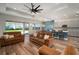 A combined living and dining area feature wood floors and backyard access at 3326 Acacia Bay Ave, Wesley Chapel, FL 33543