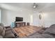 Spacious living room boasts wood floors, white walls, and comfortable seating, perfect for relaxing and entertaining at 3326 Acacia Bay Ave, Wesley Chapel, FL 33543