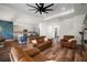 Open-concept living room featuring a modern fan, stairs, and hardwood floors at 3326 Acacia Bay Ave, Wesley Chapel, FL 33543