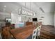 Open-concept kitchen and living area features wood floors and abundant natural light at 3326 Acacia Bay Ave, Wesley Chapel, FL 33543