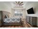 Comfortable main bedroom with a ceiling fan and a beautiful patterned bedspread at 3326 Acacia Bay Ave, Wesley Chapel, FL 33543