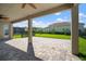 Inviting covered patio with ceiling fans offers views of the lush yard, pool and a peaceful outdoor space at 3326 Acacia Bay Ave, Wesley Chapel, FL 33543
