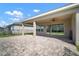 Large covered patio features an outdoor seating area, perfect for enjoying the fresh air and serene outdoor views at 3326 Acacia Bay Ave, Wesley Chapel, FL 33543