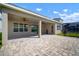 Expansive covered patio features an outdoor seating area, perfect for enjoying the beautiful backyard landscape at 3326 Acacia Bay Ave, Wesley Chapel, FL 33543