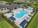 Beautiful community pool with ample seating, palm trees, and shade structures for residents to enjoy at 3326 Acacia Bay Ave, Wesley Chapel, FL 33543