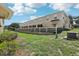Backyard view featuring the building and a white retaining wall at 3406 Dragon View Ct, Valrico, FL 33594