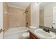 Bathroom featuring a single sink vanity, toilet, and a tiled bathtub with shower at 3406 Dragon View Ct, Valrico, FL 33594
