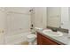 Clean bathroom featuring a tub, shower, toilet and vanity with a sink and wood cabinet at 3406 Dragon View Ct, Valrico, FL 33594