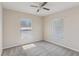 Cozy bedroom features two bright windows with blinds and neutral carpeting at 3406 Dragon View Ct, Valrico, FL 33594