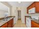 Charming kitchen featuring tile flooring, granite countertops, and a view of the bathroom at 3406 Dragon View Ct, Valrico, FL 33594