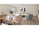 Bright living room features a dining table, modern decor, hardwood floors, and a comfortable seating area at 3406 Dragon View Ct, Valrico, FL 33594