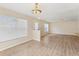 Light-filled living room with wood floors, sliding doors, and access to the kitchen, creating an inviting space at 3406 Dragon View Ct, Valrico, FL 33594