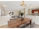 Open floor plan seamlessly connects the dining area, living room, and kitchen, with hardwood flooring at 3406 Dragon View Ct, Valrico, FL 33594