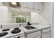 Bright kitchen with breakfast bar and view of the living area, showcasing its open, airy design at 36750 Us 19 N # 20311, Palm Harbor, FL 34684